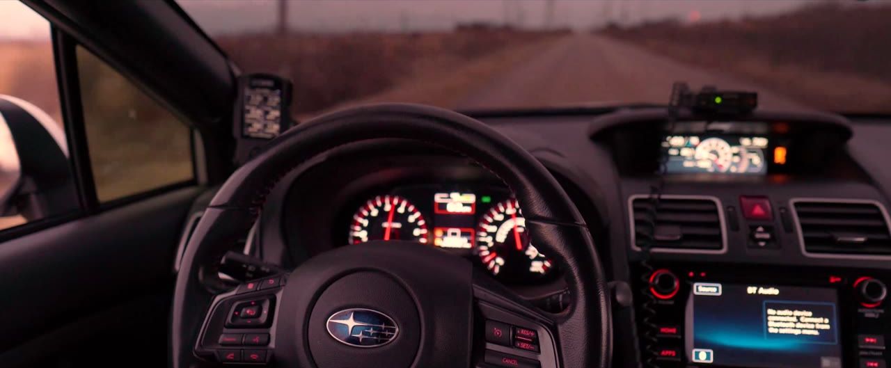 Driver view inside a Subaru at dusk