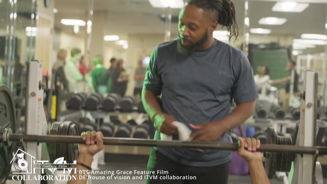 An actor at a gym bench during filming