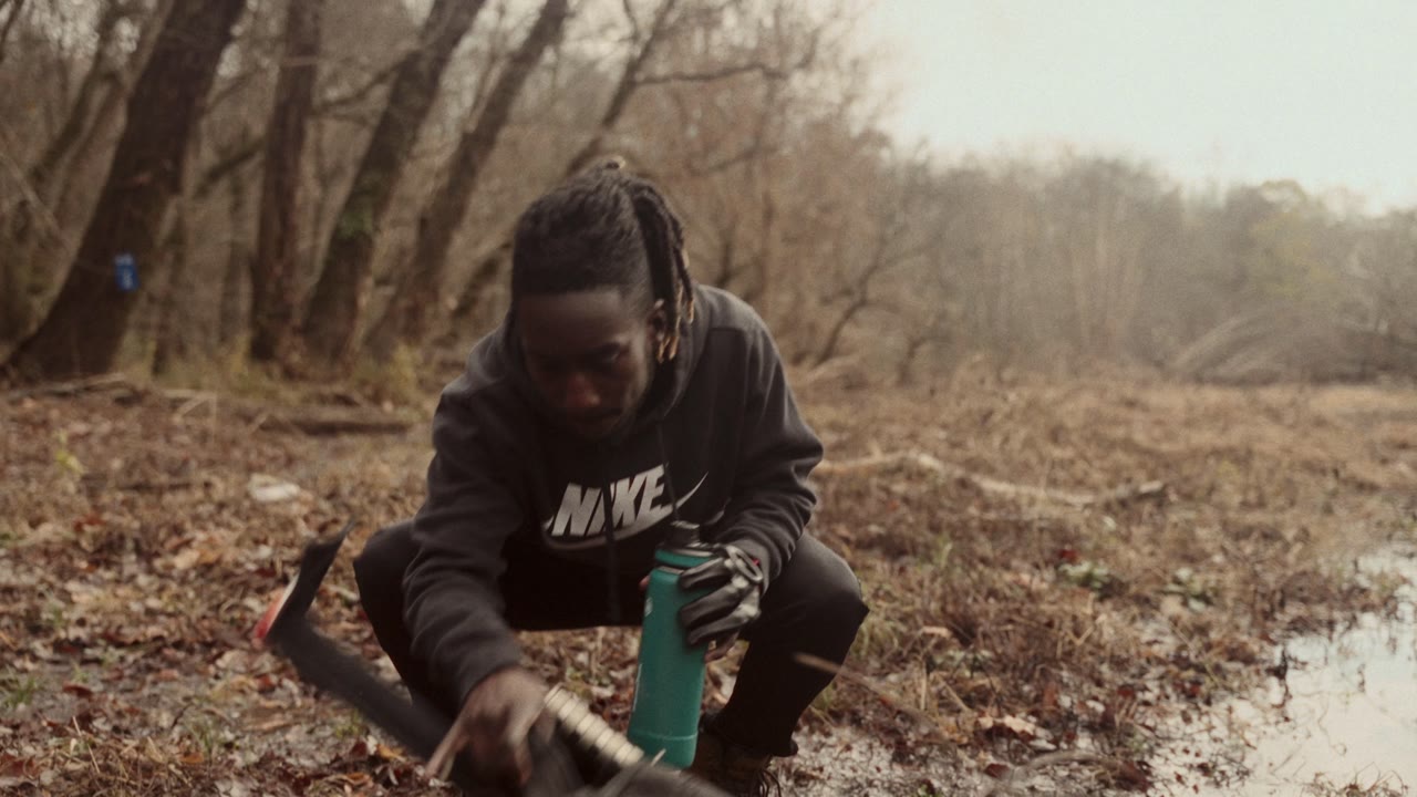 A survivor crouched in a winter field
