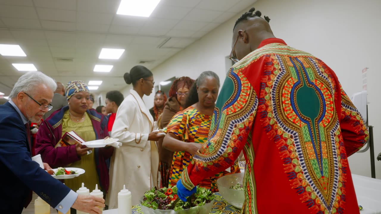 Members in colorful dress serving food