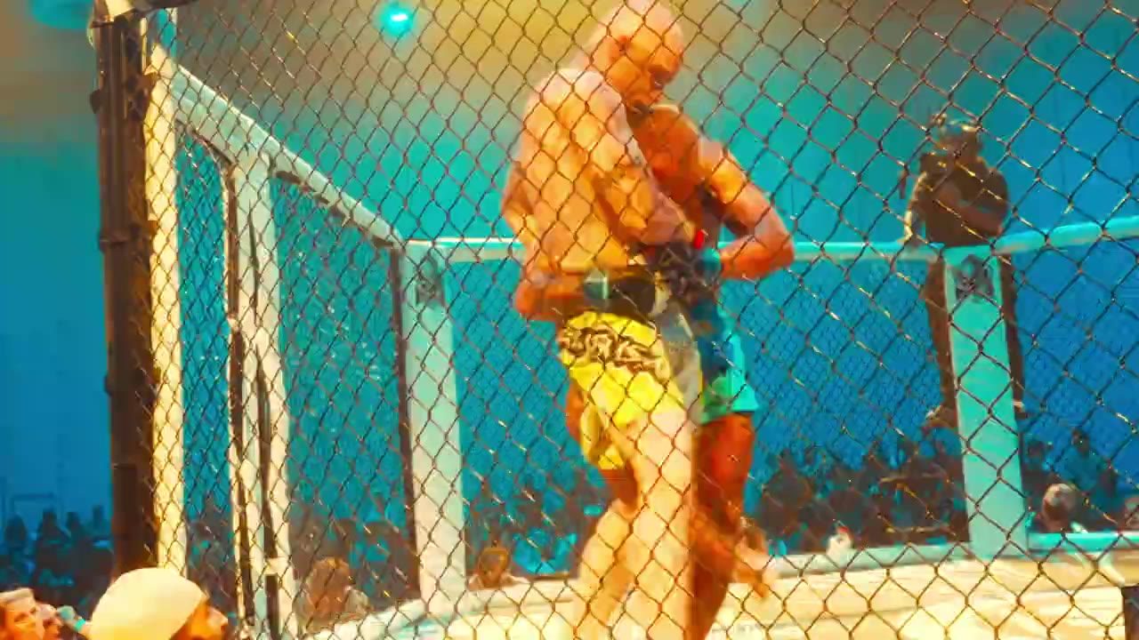A fighter in a lit cage during a combat sports event