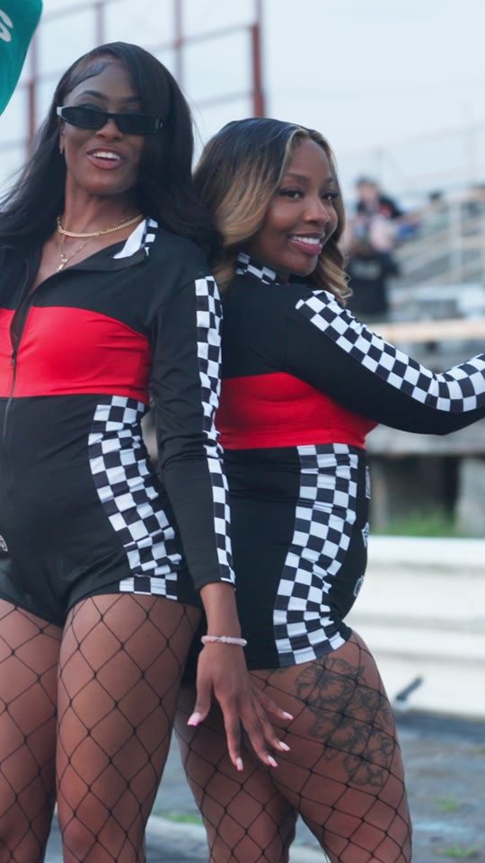 Two models in race outfits
