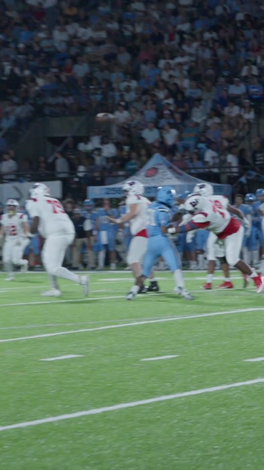 A football play under stadium lights