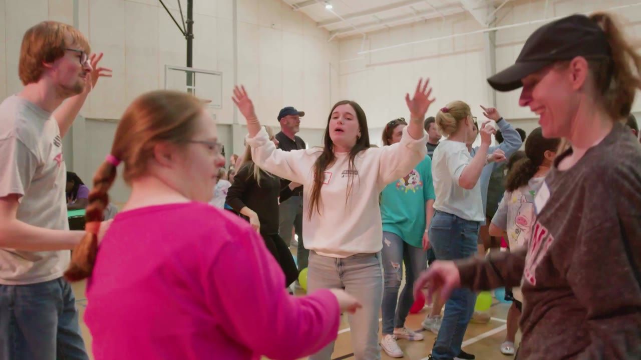 Volunteers celebrating together in a gym at Asbury Serve Day