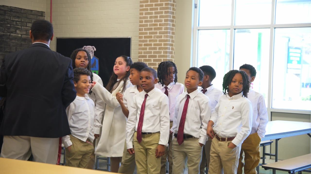 Students in ties lined up in a classroom