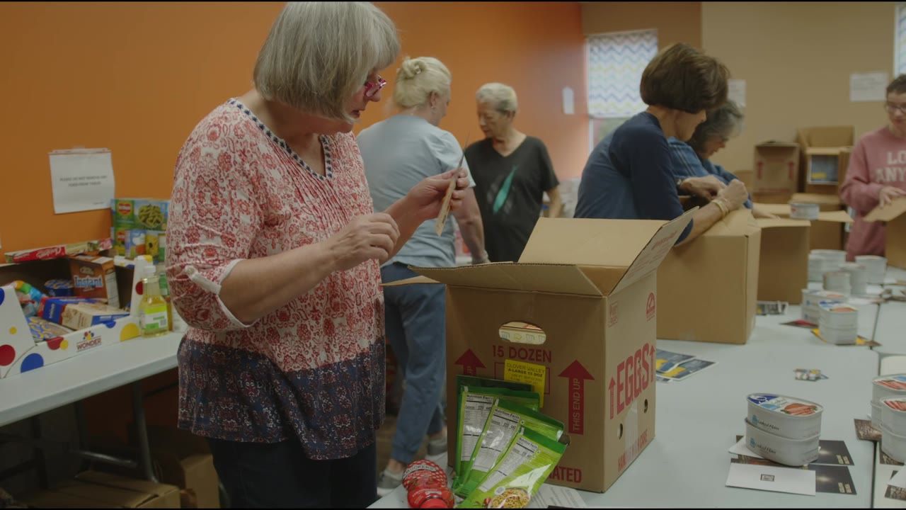 Volunteers packing food boxes