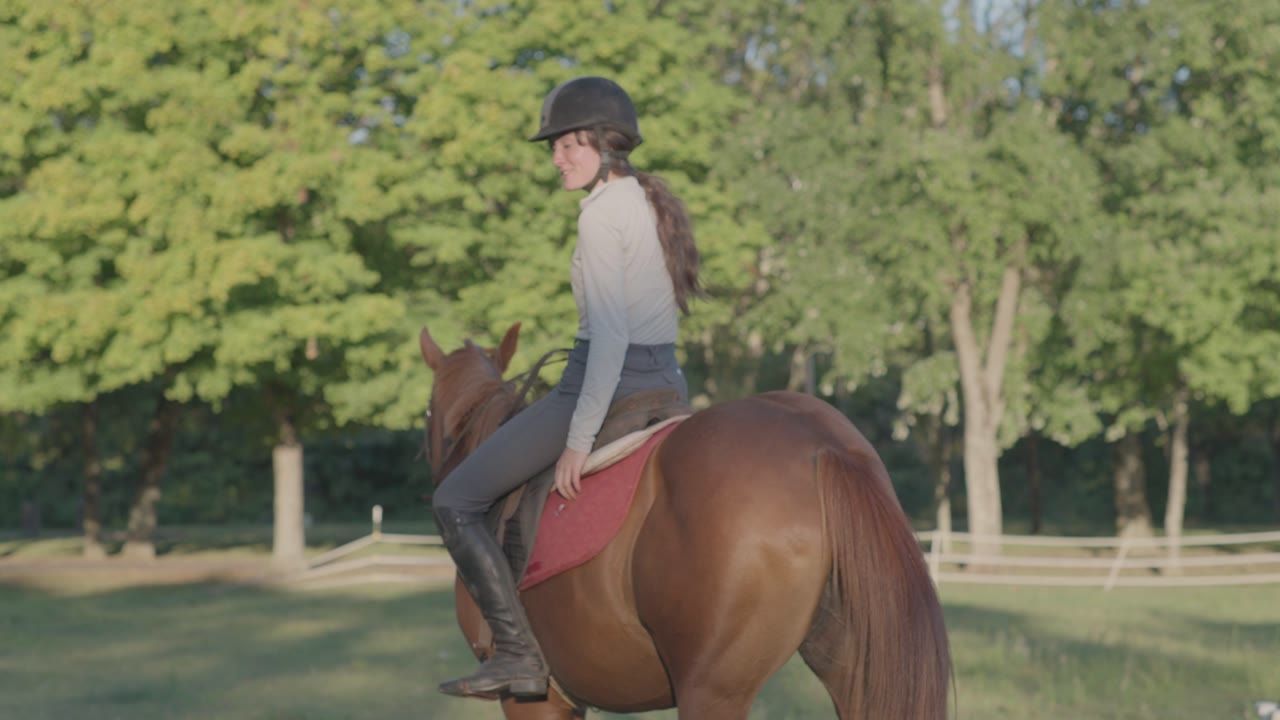 Callie on horseback in a sunny pasture