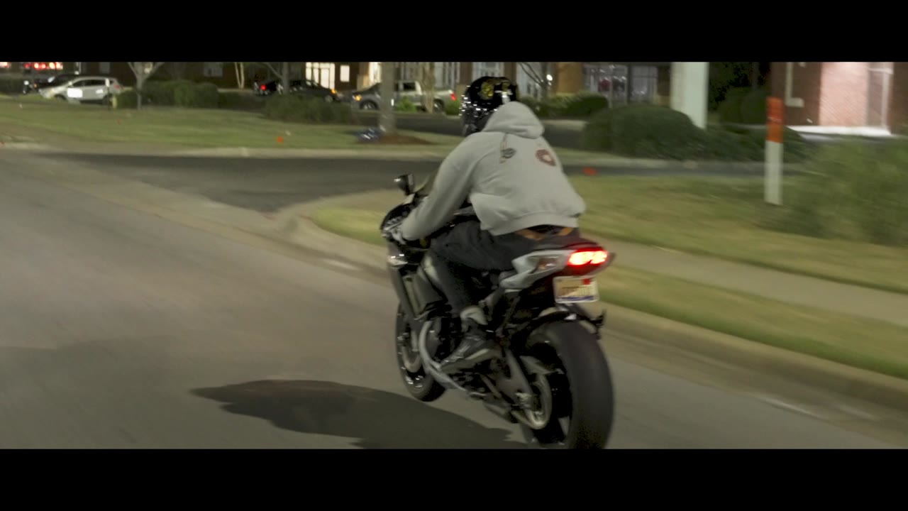 A rider leaning a sport bike through a turn at dusk