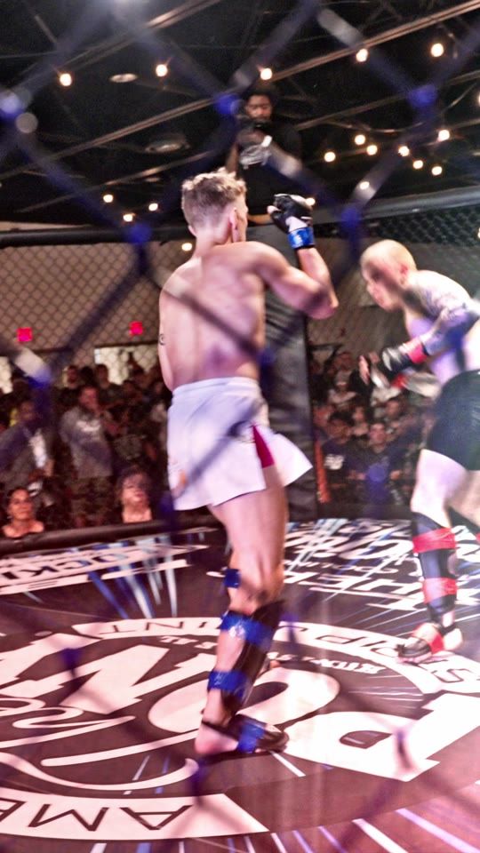 A fighter kicking in the cage