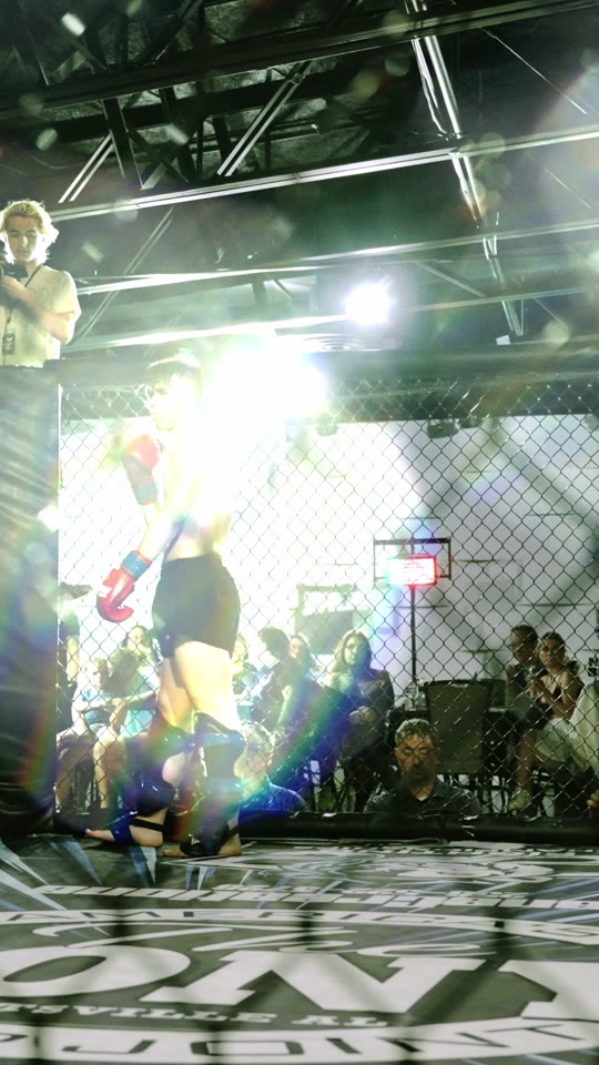 A fighter entering a lit cage