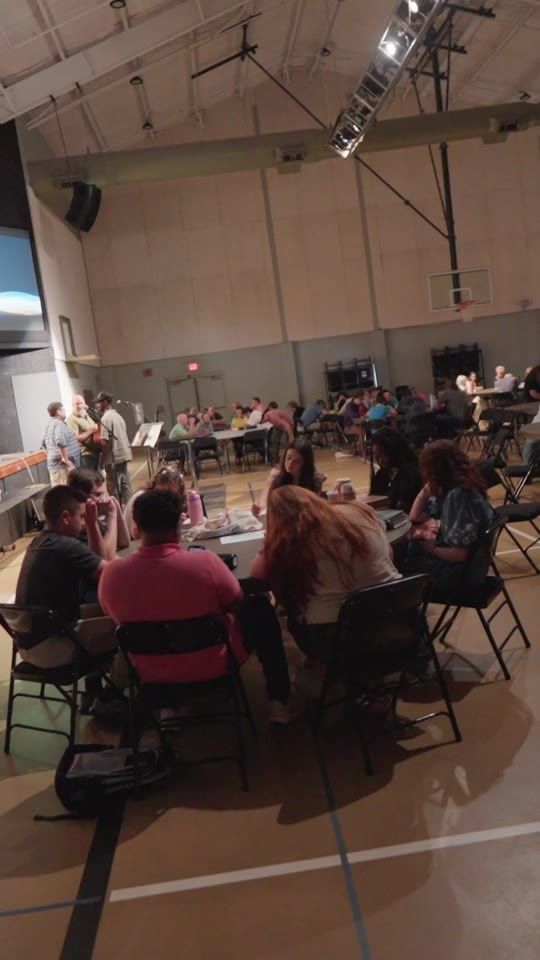 A crowd seated in a gym