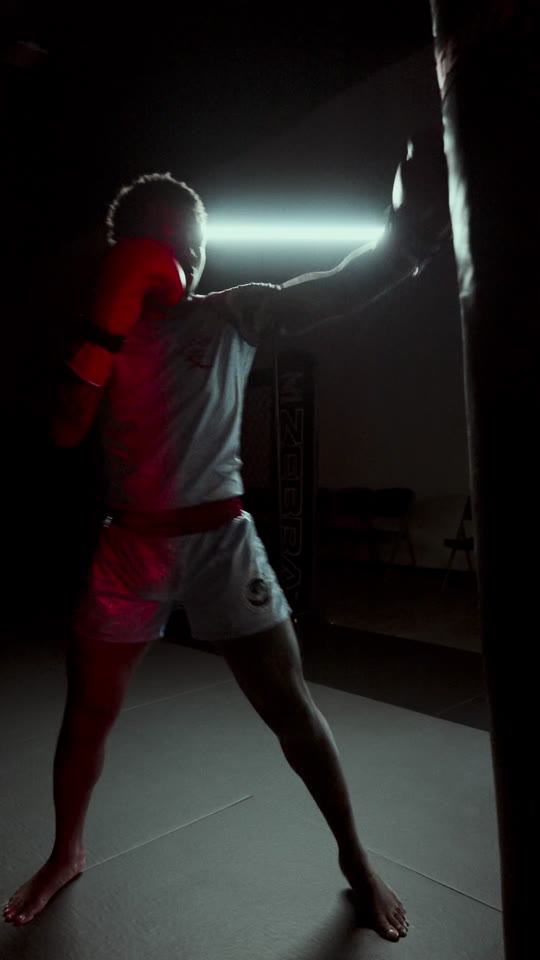 A fighter silhouetted against a light bar